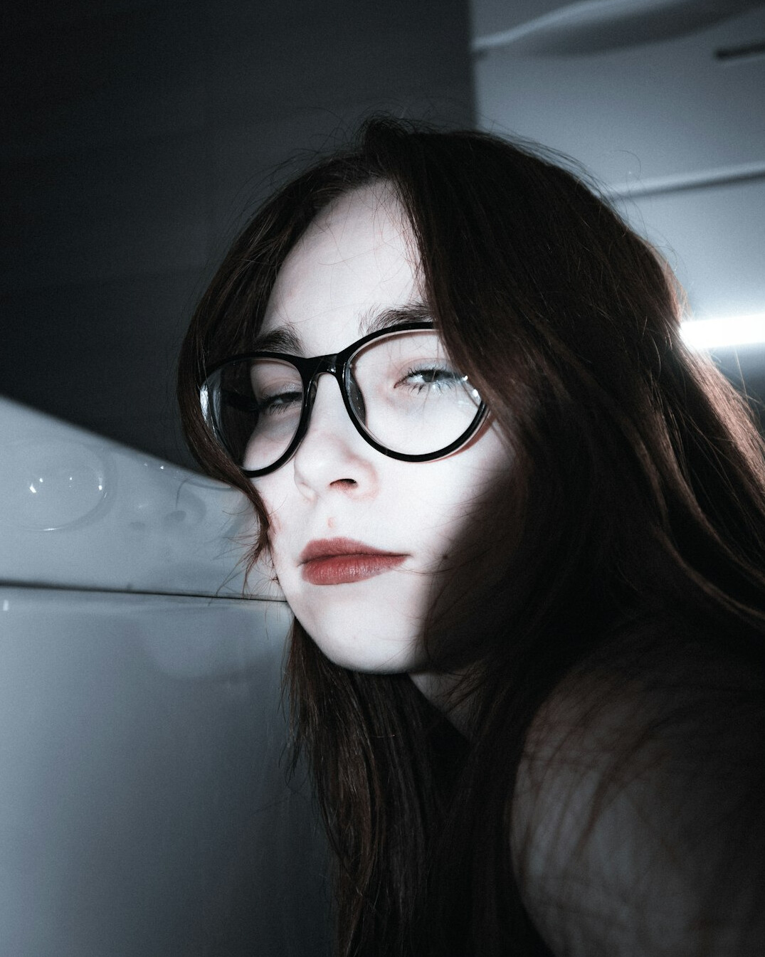 Studio portrait of a young woman with glasses