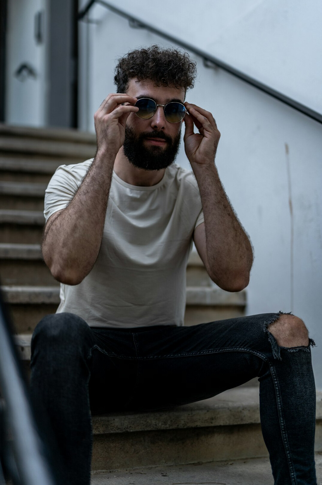 Studio portrait of a bearded man with glasses